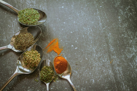 Spoons with spices and herbs on the table. Toned.の写真素材