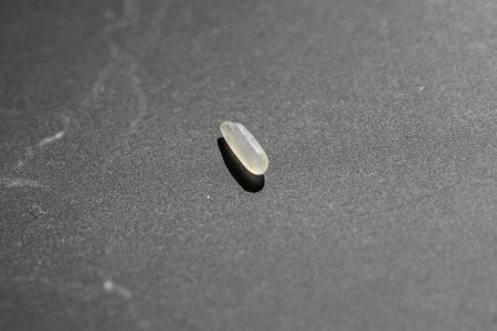 Close up of uncooked rice grain on black background. Healthy food concept.の写真素材