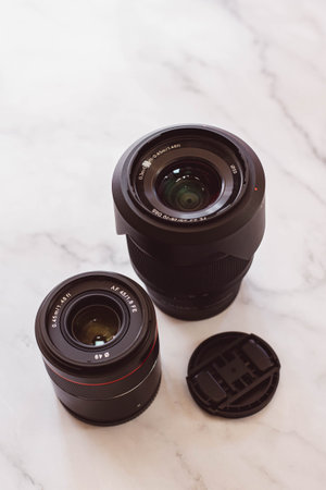 lens and camera lenses on white marble background, shallow DOF