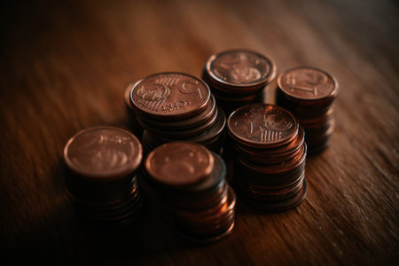 Stack of coins on wooden table with shallow depth of field. Toned.の写真素材