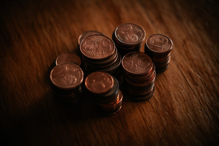 Coins stacked on each other in different positions. Shallow depth of field. Toned.