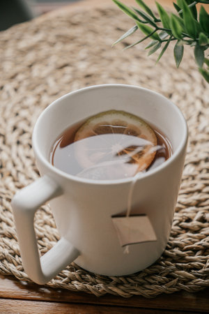 Tea cup with tea bag and lemon on wooden table, stock photoの写真素材