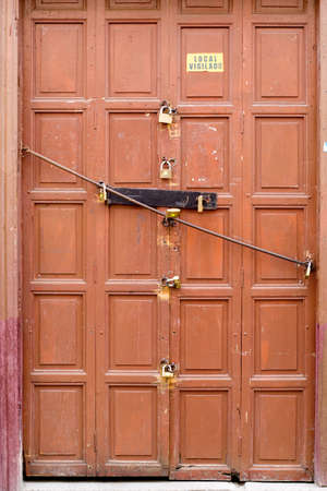 8 locks on an old brwon door, Loja Ecuador   editorial のeditorial素材