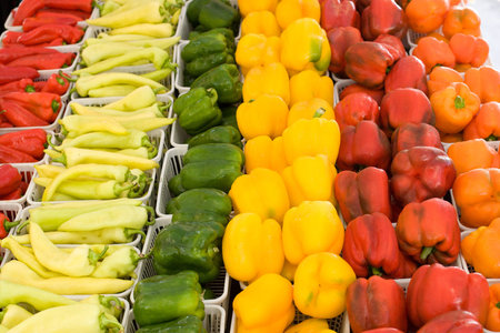Orange, yellow,green and red peppers displayed for sale at farmers market  yellow dominate,orange...