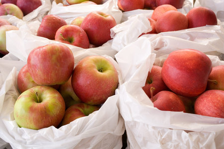 Fresh red ripe apples on display and for sale at farmers market  Selective focus