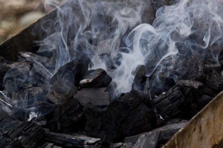 Close-up of smoke rising from Charcoal used in cooking grillの写真素材