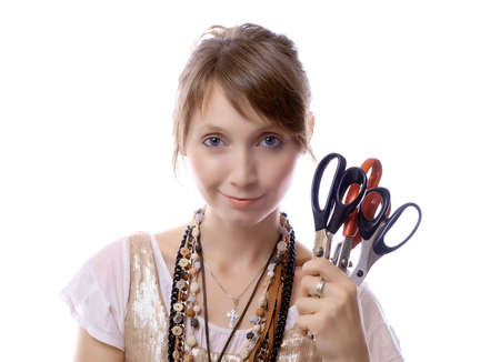 young girl holds in her hand scissorsの写真素材