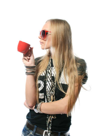 beautiful girl in red glasses drinks from a red mug.isolated on white backgroundの写真素材