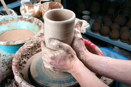 hands of a potter, creating an earthen jar on the circleの写真素材