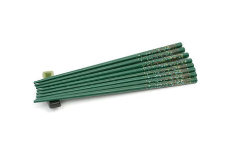 Eight green chopsticks on a supportの写真素材