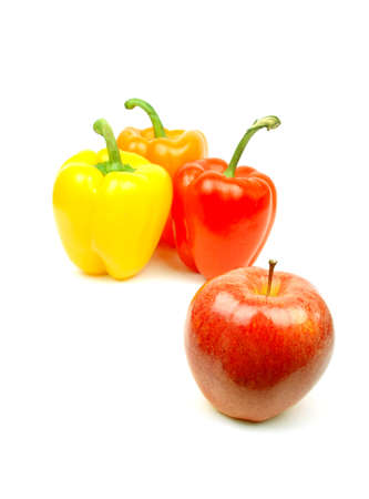 apple and yellow, red and green pepper on whiteの写真素材