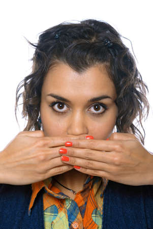 Closeup portrait of young woman covering her mouth with both handsの写真素材