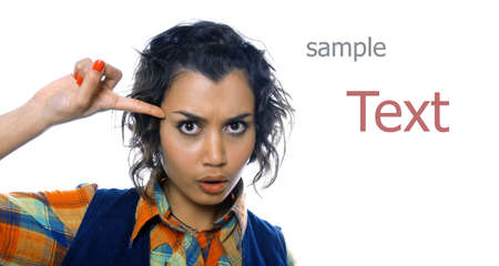 Pretty girl twists her finger to her templeの写真素材