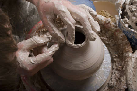 hands of a potter, creating an earthen jar on the circleのeditorial素材