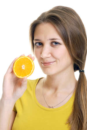 young woman with orange slice studio shotの写真素材