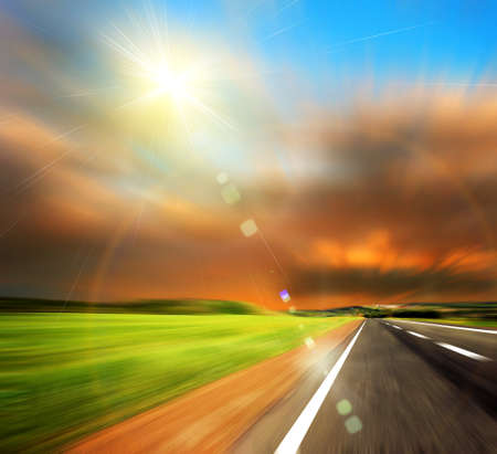 road and blured sky with sunの写真素材