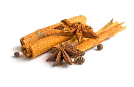 star anise with cinnamon sticks isolated on whiteの写真素材