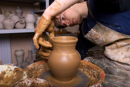 hands of a potter, creating an earthen jar on the circleの写真素材
