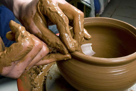 hands of a potter, creating an earthen jar on the circleの写真素材