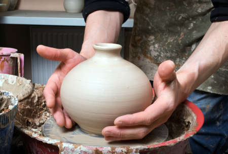 hands of a potter, creating an earthen jar on the circleの写真素材