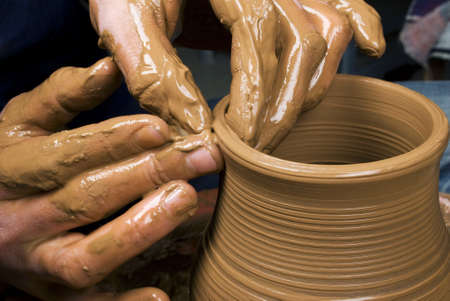 hands of a potter, creating an earthen jar on the circleの写真素材