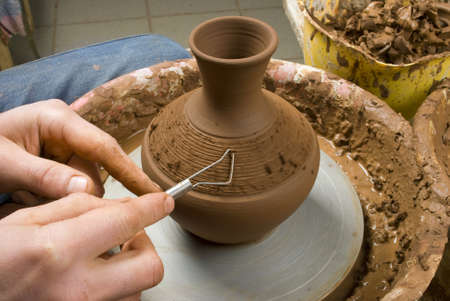hands of a potter, creating an earthen jar on the circleの写真素材