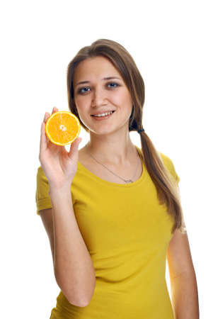 young woman with orange slice studio shotの写真素材