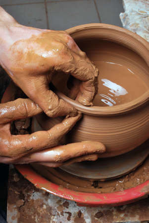 hands of a potter, creating an earthen jar on the circleの写真素材