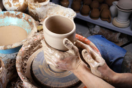 hands of a potter, creating an earthen jar on the circleの写真素材