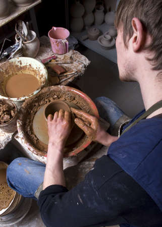 hands of a potter, creating an earthen jar on the circleの写真素材