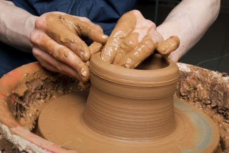 hands of a potter, creating an earthen jar on the circleの写真素材