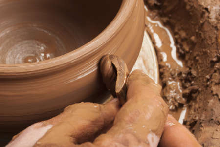hands of a potter, creating an earthen jar on the circleの写真素材