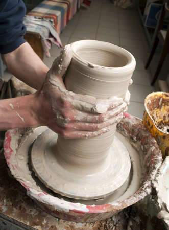 hands of a potter, creating an earthen jar on the circleの写真素材