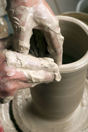 hands of a potter, creating an earthen jar on the circleの写真素材