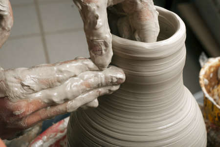 hands of a potter, creating an earthen jar on the circleの写真素材