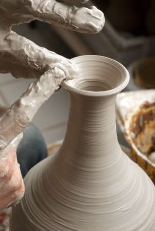 hands of a potter, creating an earthen jar on the circleの写真素材