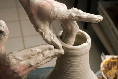 hands of a potter, creating an earthen jar on the circleの写真素材