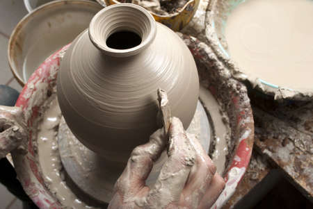 hands of a potter, creating an earthen jar on the circleの写真素材