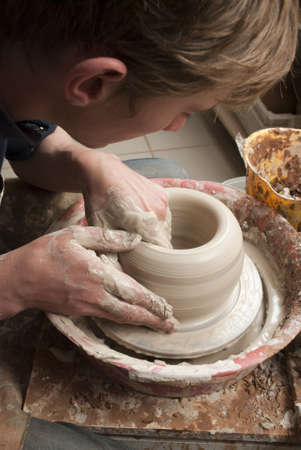 hands of a potter, creating an earthen jar on the circleの写真素材
