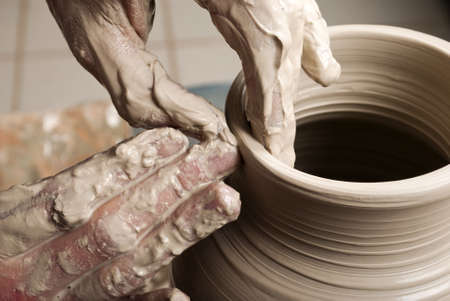 hands of a potter, creating an earthen jar on the circleの写真素材