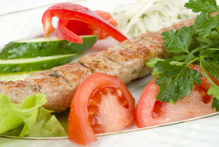 Grilled meat with fresh vegetables and herbsの写真素材