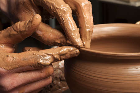 hands of a potter, creating an earthen jar on the circleの写真素材