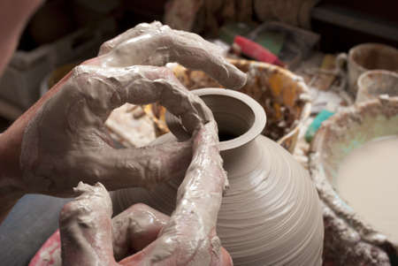 hands of a potter, creating an earthen jar on the circleの写真素材