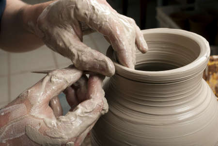 hands of a potter, creating an earthen jar on the circleの写真素材