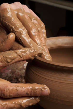 hands of a potter, creating an earthen jar on the circleの写真素材