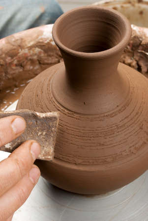 hands of a potter, creating an earthen jar on the circleの写真素材