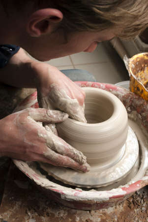 hands of a potter, creating an earthen jar on the circleの写真素材