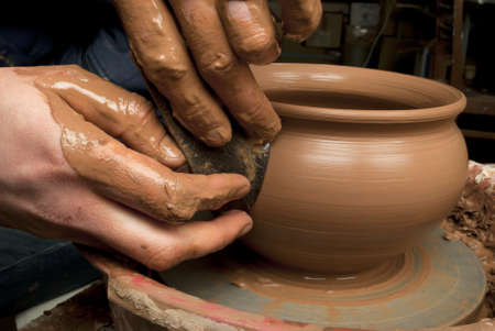 hands of a potter, creating an earthen jar on the circleの写真素材