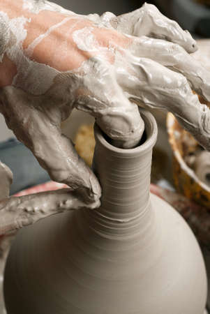 hands of a potter, creating an earthen jar on the circleの写真素材