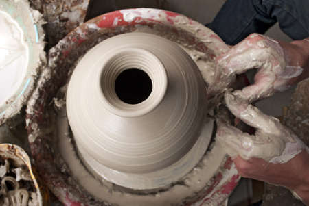 hands of a potter, creating an earthen jar on the circleの写真素材